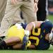 Michigan running back Drake Johnson holds his knee in pain after an injury in the third quarter against Central Michigan at Michigan Stadium on Saturday, August 31, 2013. Melanie Maxwell | AnnArbor.com